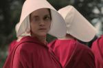 Promotional image for Hulu's Handmaid's Tale shows multiple women dressed in bonnets and red dresses.
