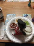 Photo of the components of a waking taco with the plate sitting on bingo cards.